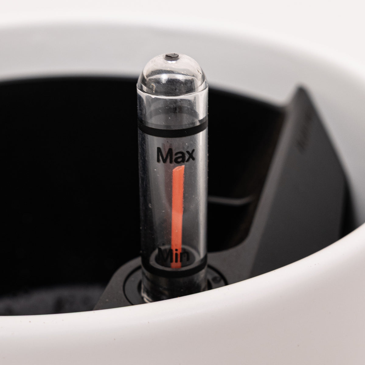 Close-up of the red water-level gauge on a Plantwell self-watering planter